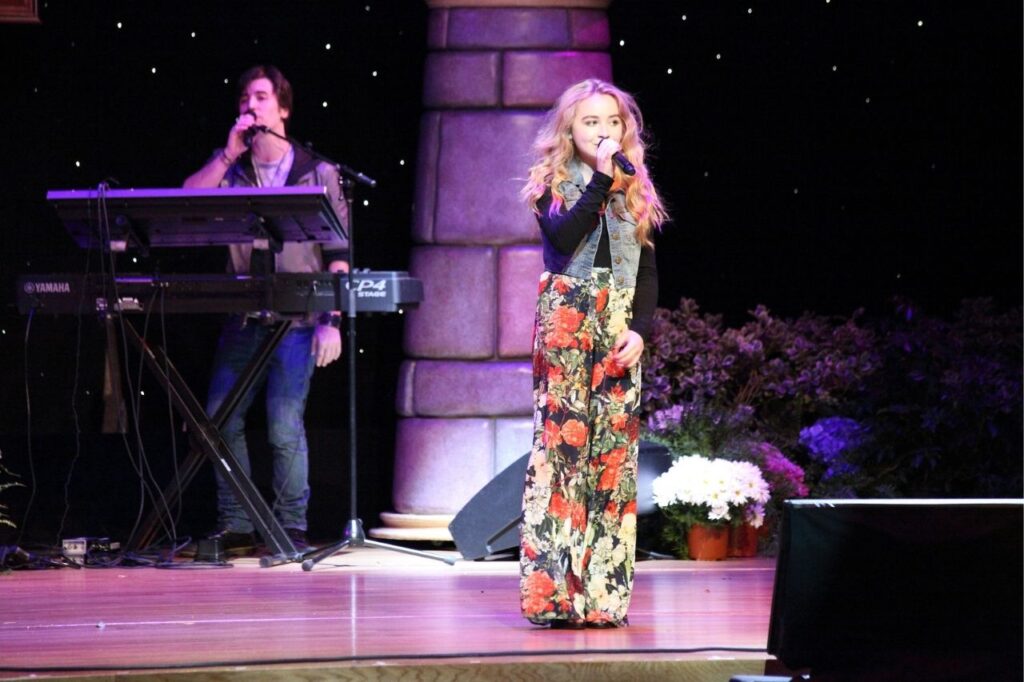 Sabrina Carpenter performing songs from her albums in a live music show on stage