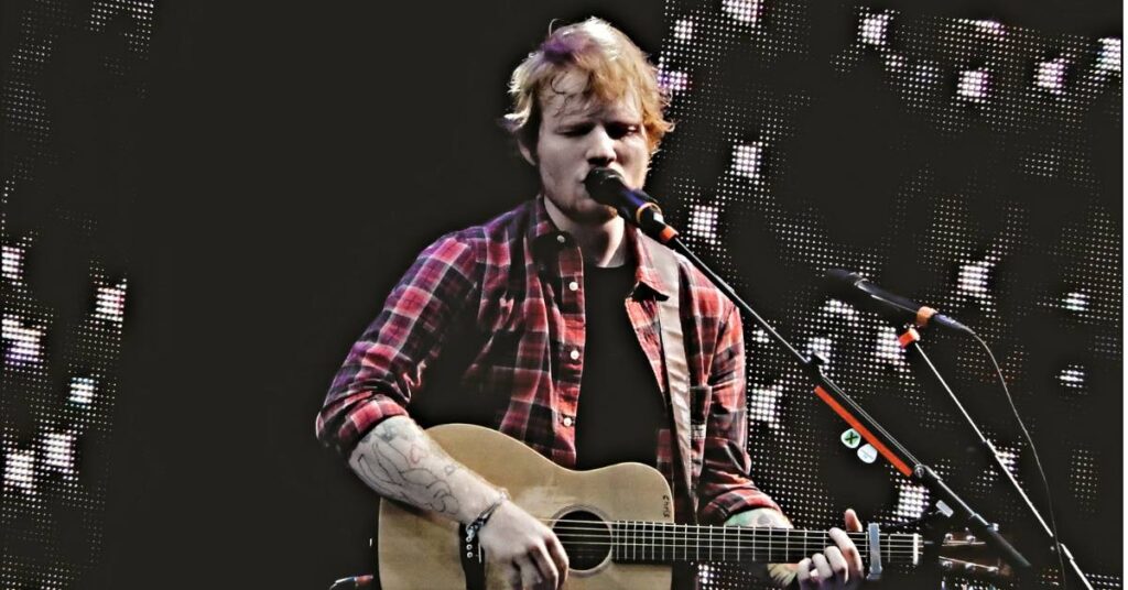 Ed Sheeran singing live on stage while performing songs from his popular albums